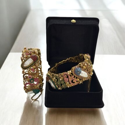 Gold-plated bracelets with pearls and colorful gemstones, set in intricate designs.