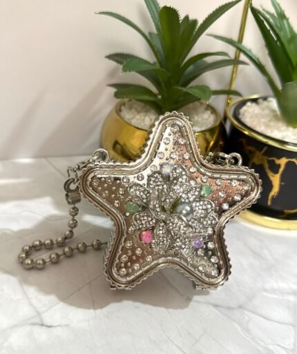 Silver star-shaped clutch with a multi-colored floral crystal design, featuring a detachable chain strap.