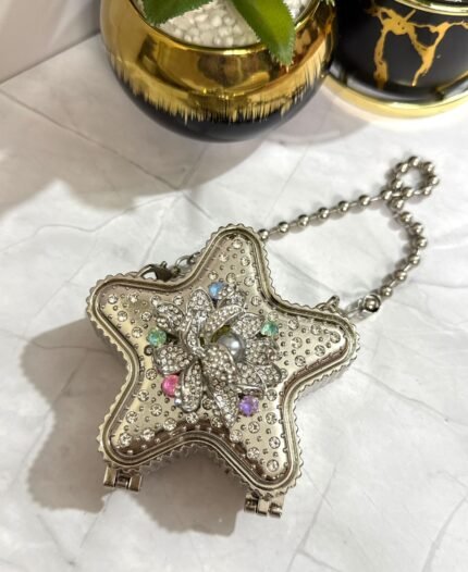 Silver star-shaped clutch with a multi-colored floral crystal design, featuring a detachable chain strap.