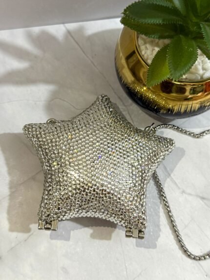 Silver star-shaped clutch with crystal embellishments, featuring a detachable silver chain strap.