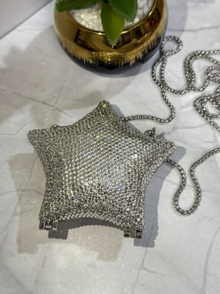 Silver star-shaped clutch with crystal embellishments, featuring a detachable silver chain strap.